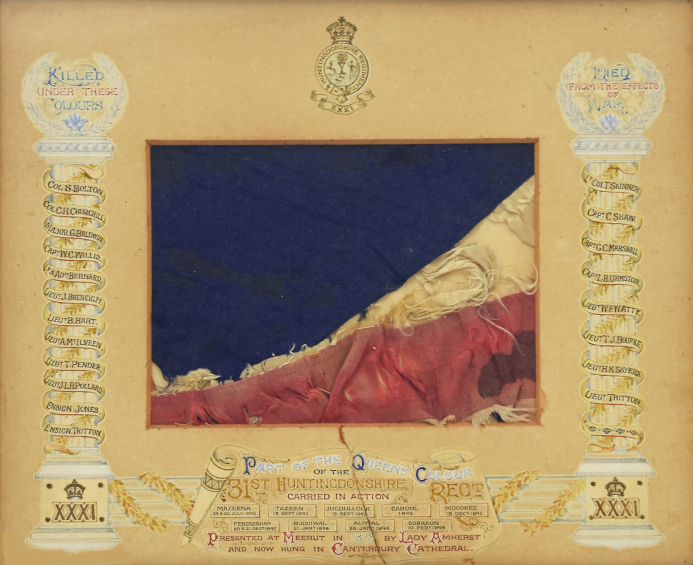 A ragged piece of a flag, with pieces of red, white and blue cloth.