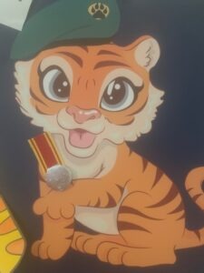 PWRR Museum mascot Tara Tiger is sat with her own medal on